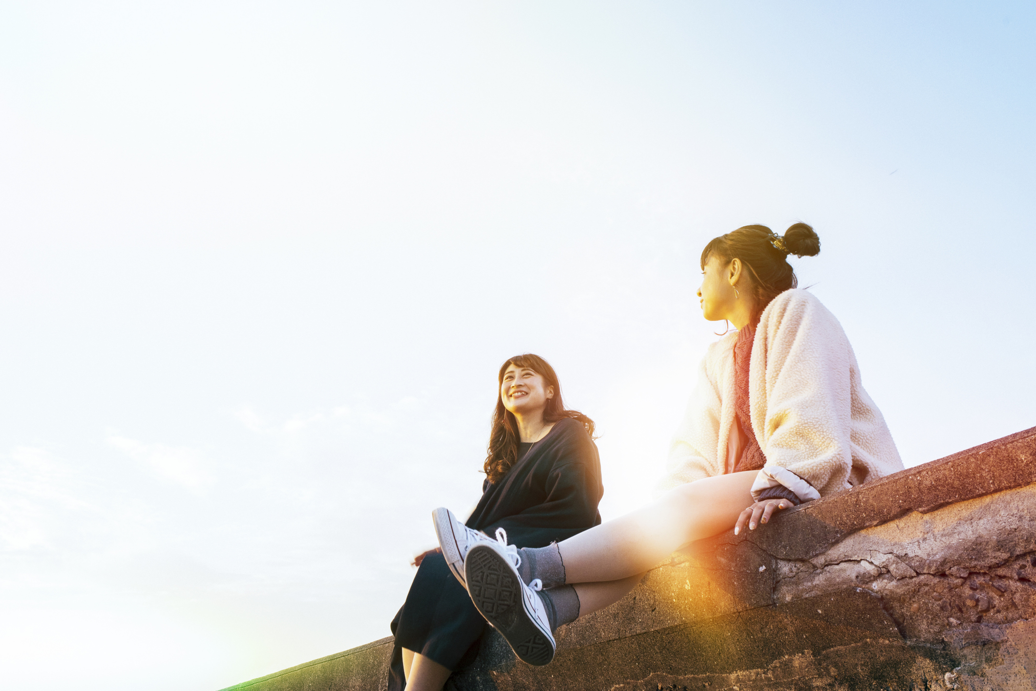 Two young women sitting and talking