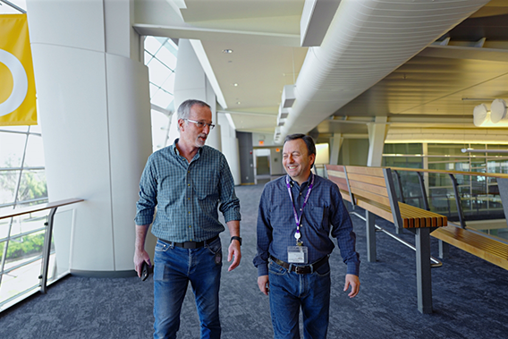 Two employees of Point32Health walking down a hallway