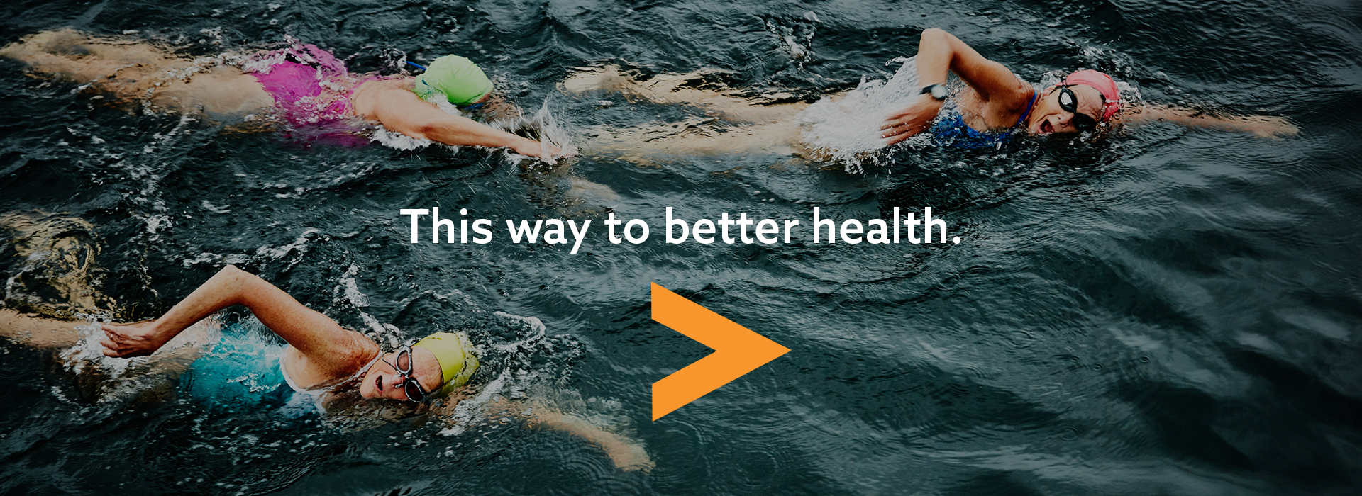women swimming left to right in a body of water