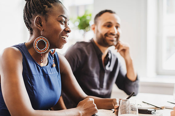 coworkers listening to a conversation during a meeting in the office