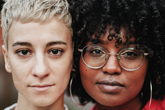 two diverse women looking straight at the camera with serious expressions